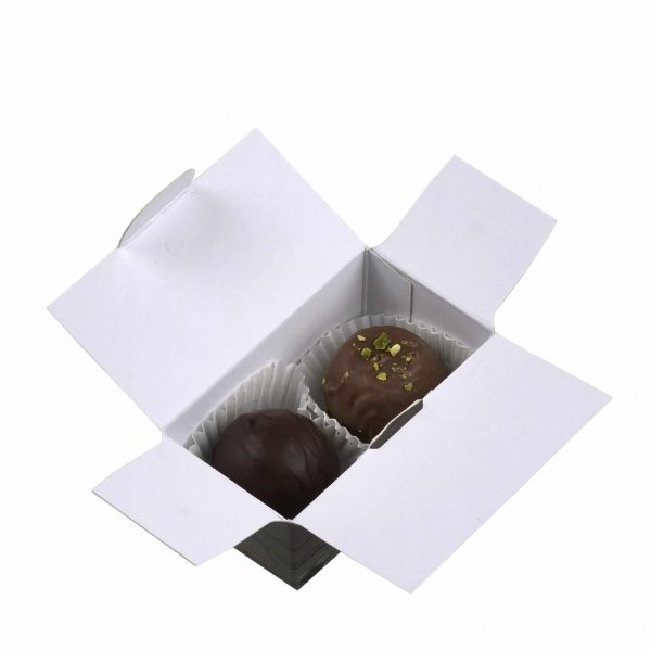 2er Schatulle "Essigschleckerle" von Schell Schokoladen befinden sich zwei Pralinen einmal die Riesling Schleckerle und die Balsam Schleckerle in einer Schachtel mit Holzmuster.