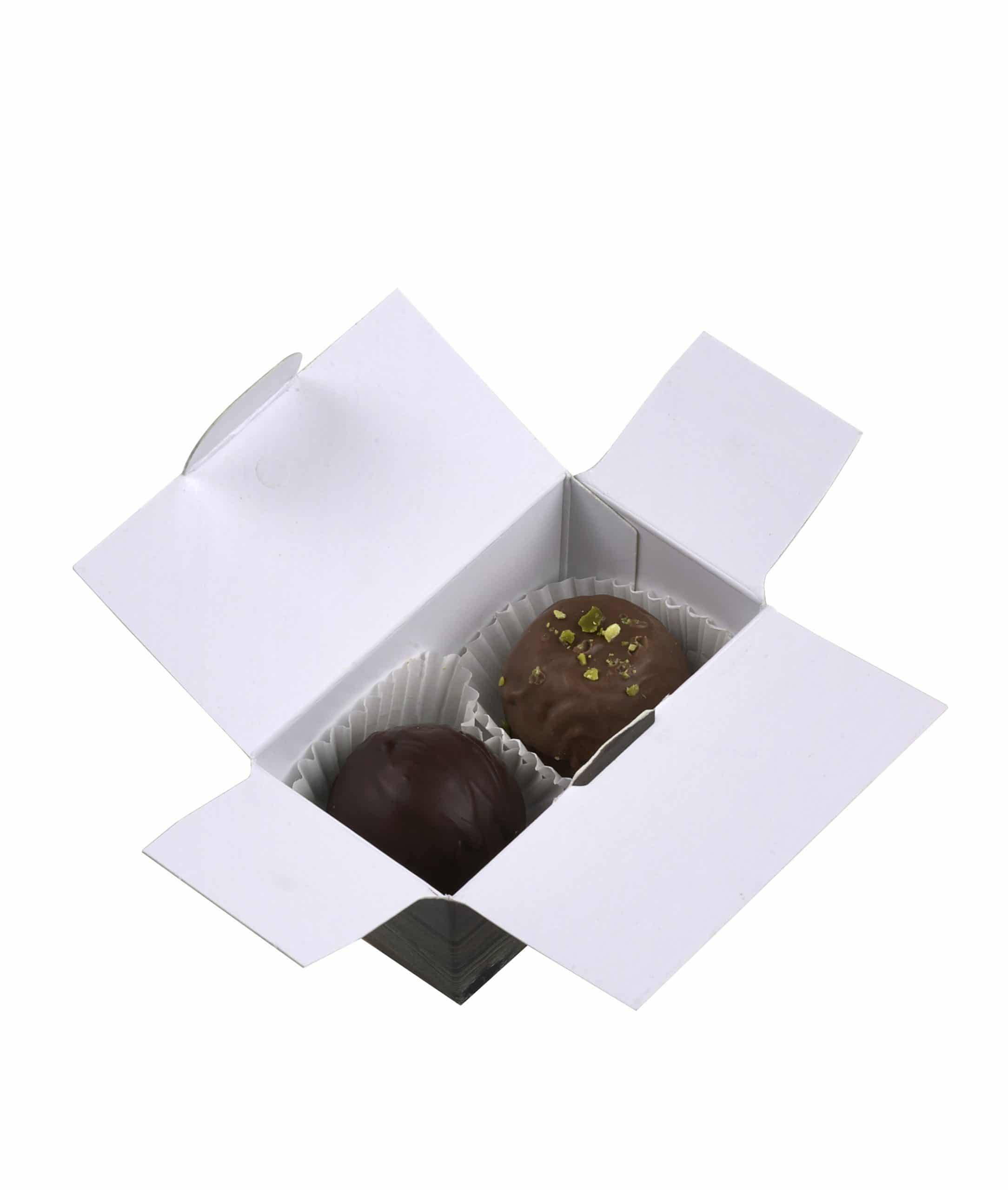 2er Schatulle "Essigschleckerle" von Schell Schokoladen befinden sich zwei Pralinen einmal die Riesling Schleckerle und die Balsam Schleckerle in einer Schachtel mit Holzmuster.